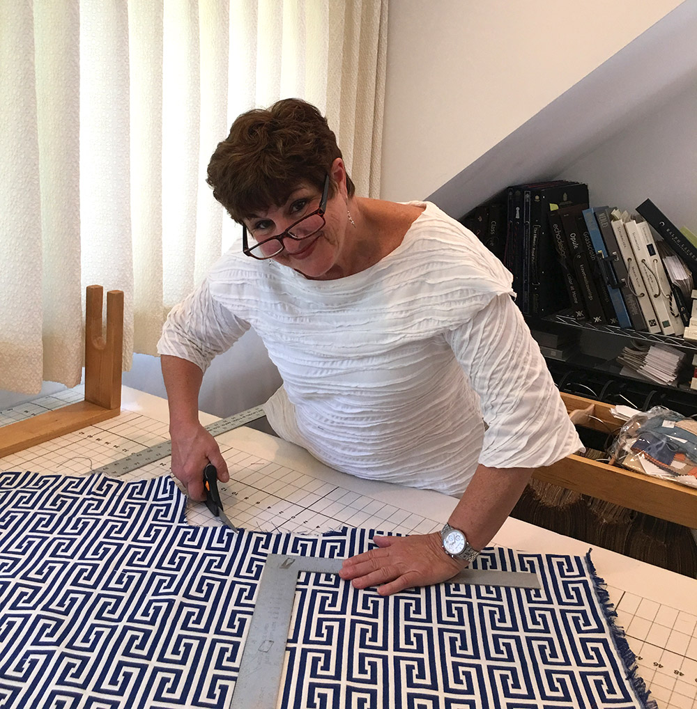 Debbie Farrand of Dressing Rooms Interior Design working on a custom fabric piece for a client.